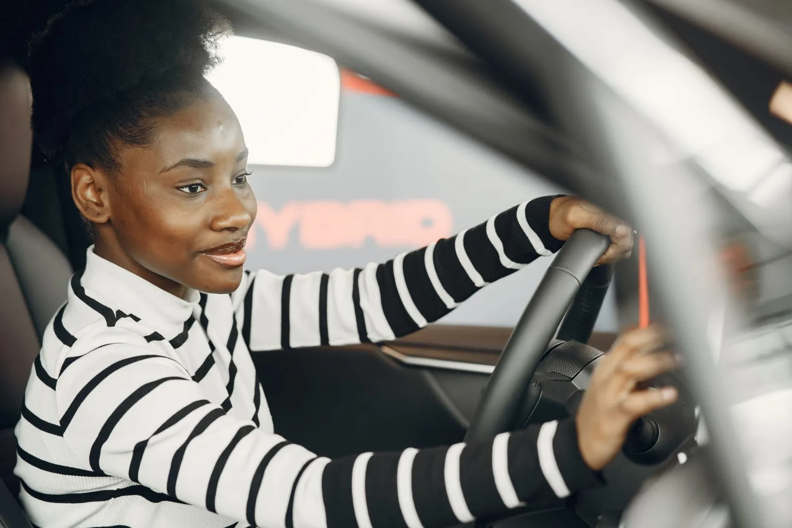 Smiling driver behind the wheel of her car