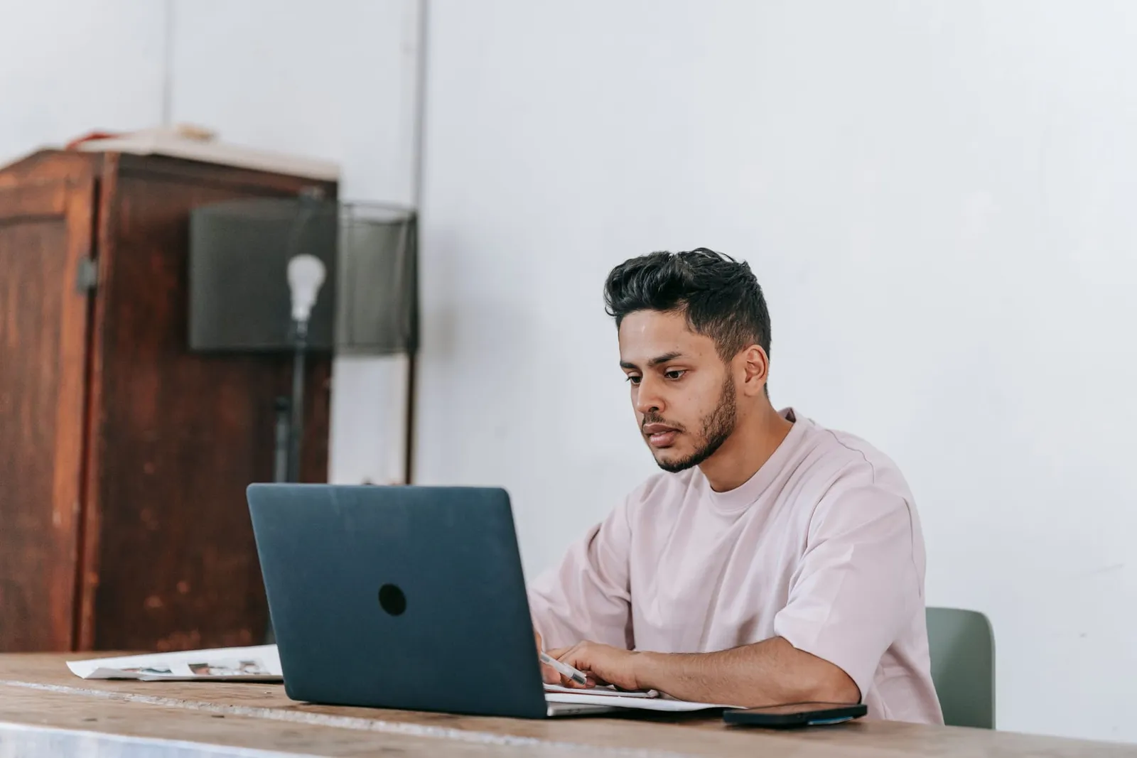Self-employed man working on a laptop at a table
